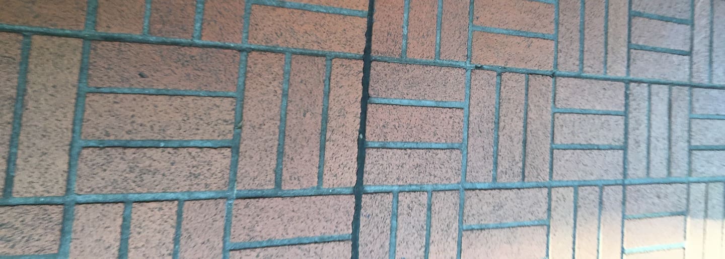 Brick wall with a grid pattern, showing a close-up of the texture and design.