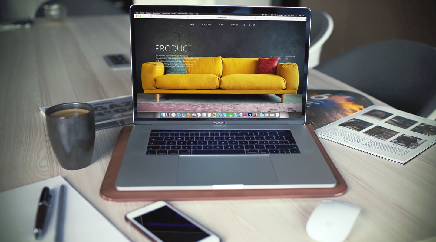 MacBook Pro displaying a website for a yellow sofa, content marketing inspiration