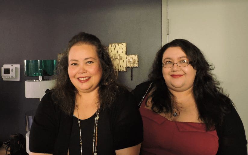 Monica Ortiz and a friend smiling at an event, enjoying an eventful life.