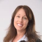 Smiling woman with brown hair and a light blue shirt