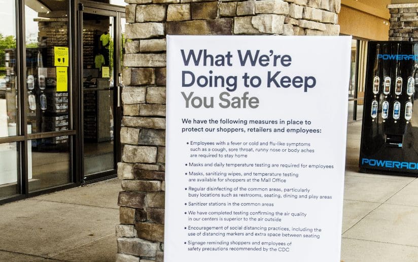 Sign at a shopping center listing COVID-19 safety measures for shoppers and employees. "What We're Doing to Keep You Safe.