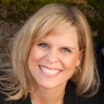 Smiling woman with a radiant smile, showcasing teeth whitening results.