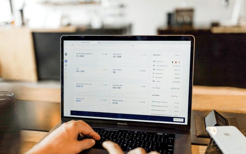 Analytics dashboard on a MacBook Pro screen showing key metrics.