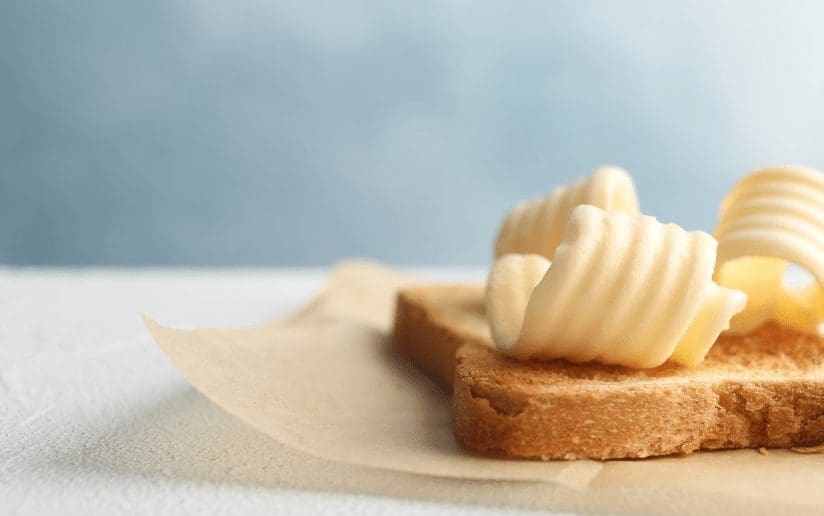 Toast with curls of butter on parchment paper