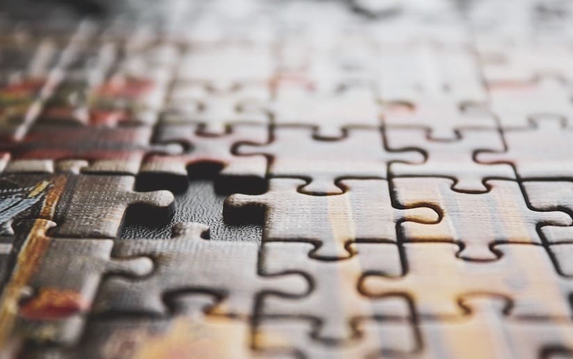 Close-up of a partially completed jigsaw puzzle with one piece missing, symbolizing marketing challenges.