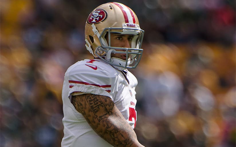 Colin Kaepernick in 49ers uniform on the field, side view. "Kaepernick v. Marketing" related.