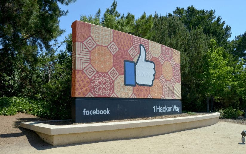 Facebook headquarters sign with "Like" icon and "1 Hacker Way" address.
