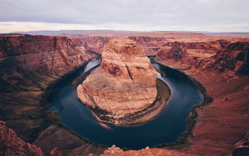 Horseshoe Bend, Arizona, with the Colorado River winding through a red rock canyon.