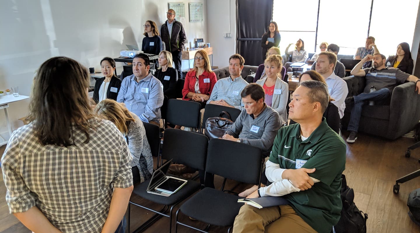 Group of people attending a consulting workshop, focused on re-engagement strategies.