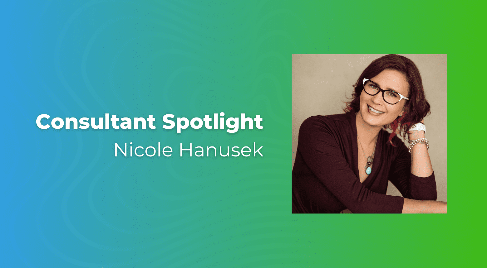 Nicole Hanusek, web design consultant, smiling in a headshot with glasses.