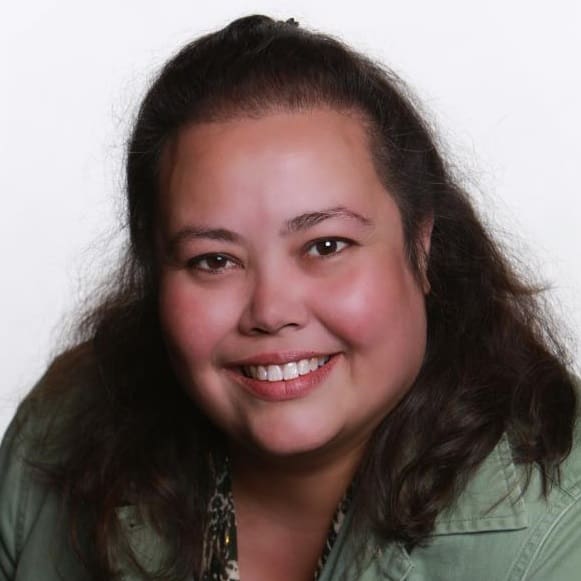 Smiling woman with dark hair and a green shirt