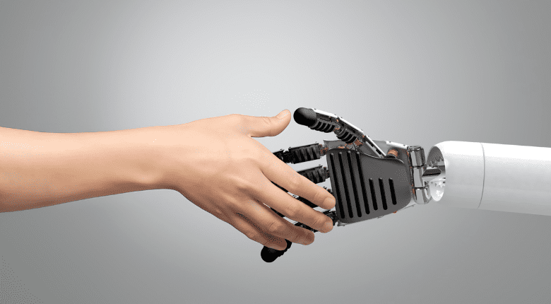 Human hand shaking robotic hand, representing AI and human collaboration in marketing.