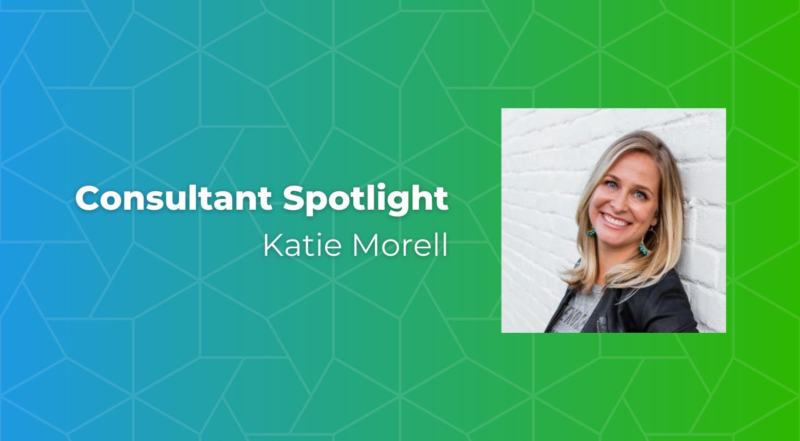 Katie Morell, Consultant Spotlight, smiling in front of a white brick wall